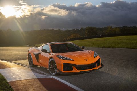 front view of 2023 chevrolet corvette z06 in amplify orange tint on a track