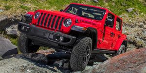 2023 jeep wrangler rubicon suv off roading up a rocky incline