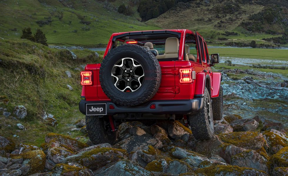 2023 jeep wrangler rubicon suv off roading over large rocks