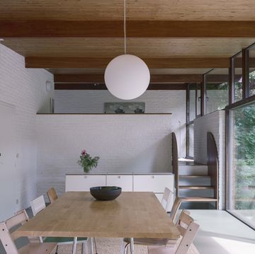 a table with a bowl and a light from the ceiling