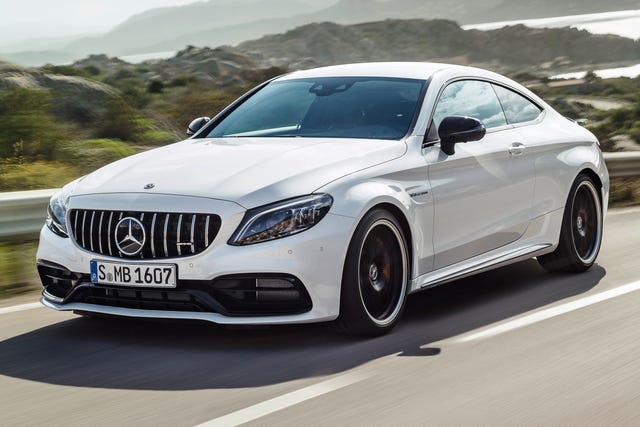 2023 mercedes amg c63 coupe driving down a coastal highway