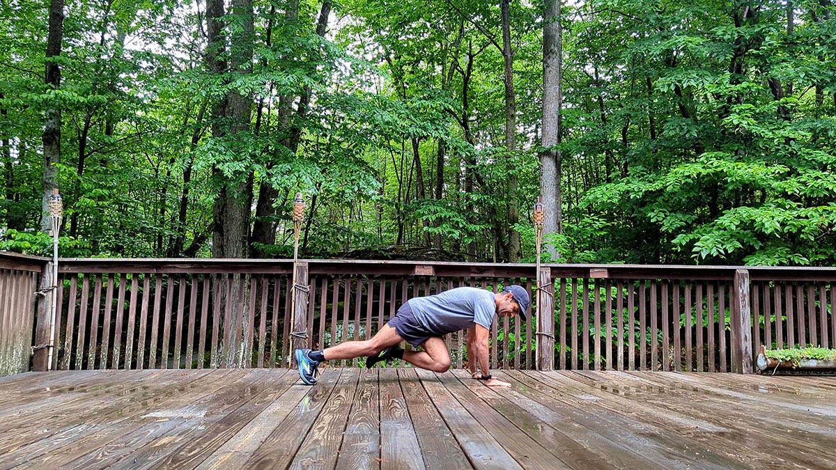 a man lying on a wooden deck