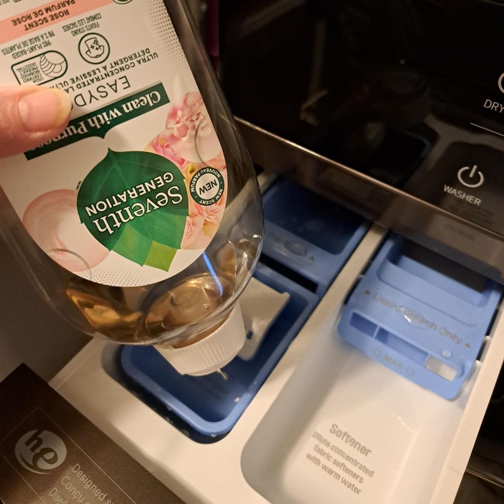 tester adding ecofriendly detergent to a washing machine dispenser