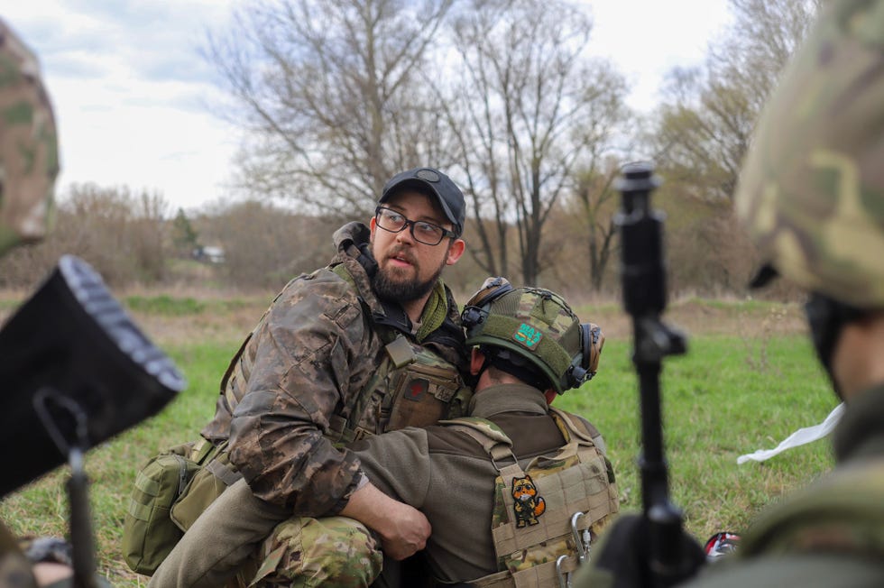 a man in camouflage holding a gun