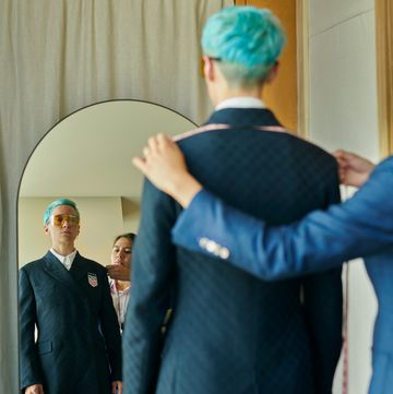 megan rapinoe gets measured for a suit