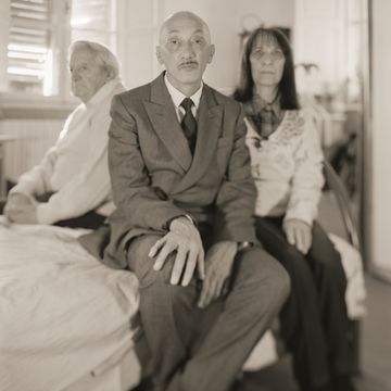 a group of people sitting on a bed
