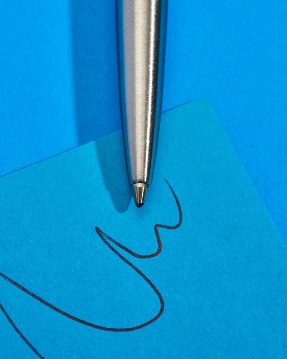 a pen on a blue surface