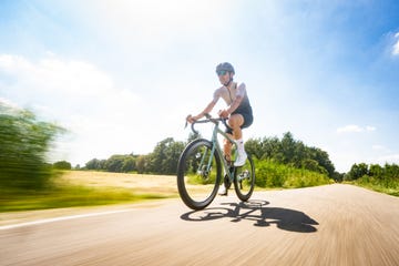 een wielrenner fietst in de zon