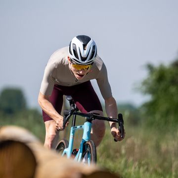 a man riding a bike next to a cow