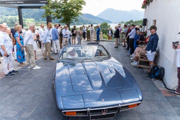 a crowd of people around a maserati