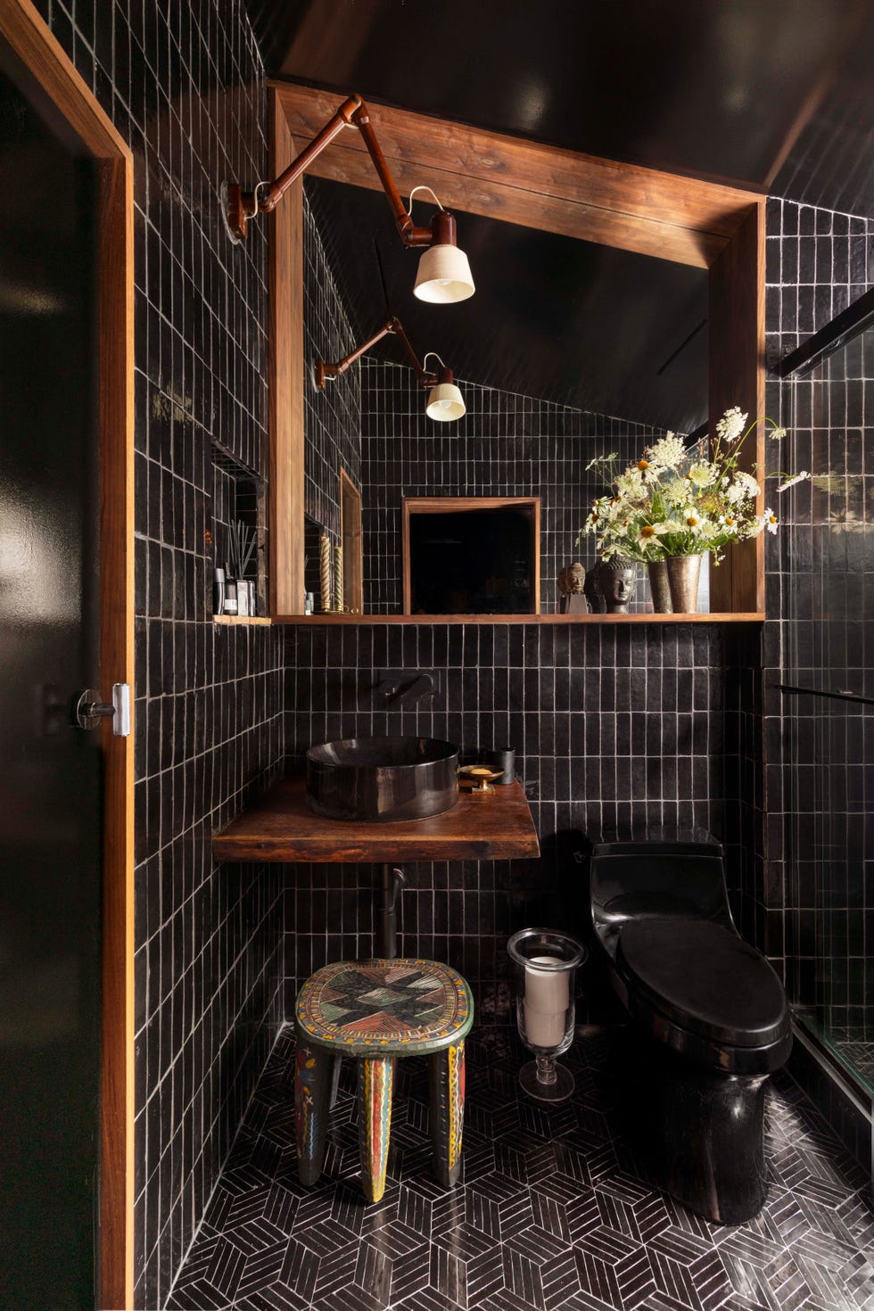 powder room in wood and black tile