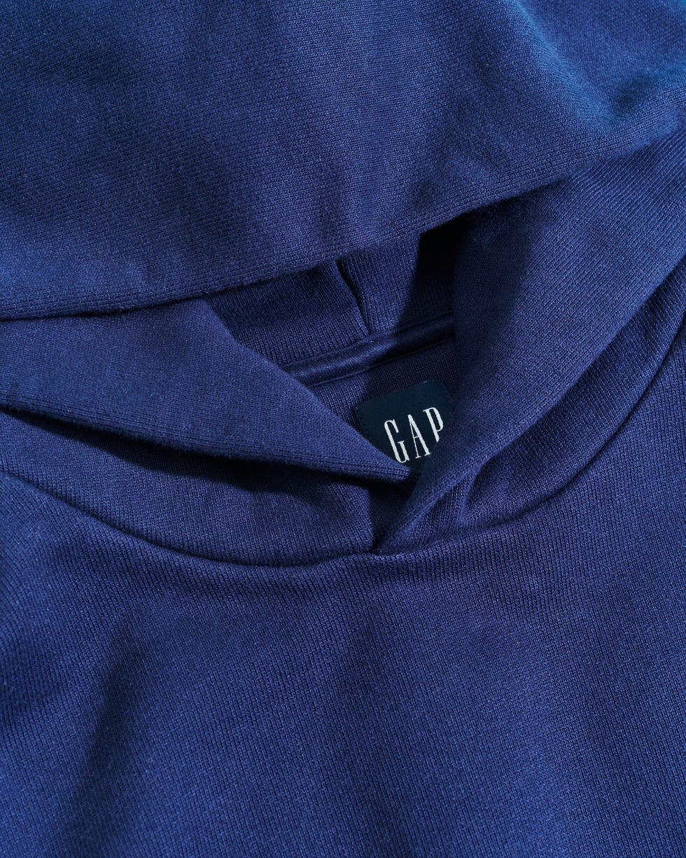 navy blue hoodie featuring a closeup of the collar and brand label