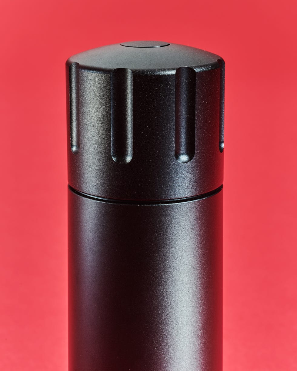 black cylindrical container with a ribbed lid