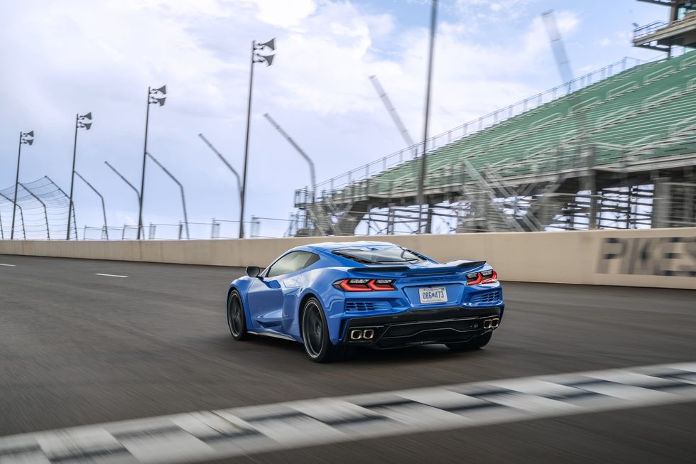 2024 corvette eray rear three quarter on track in riptide blue metallic