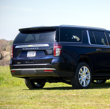 a black suv parked in a field