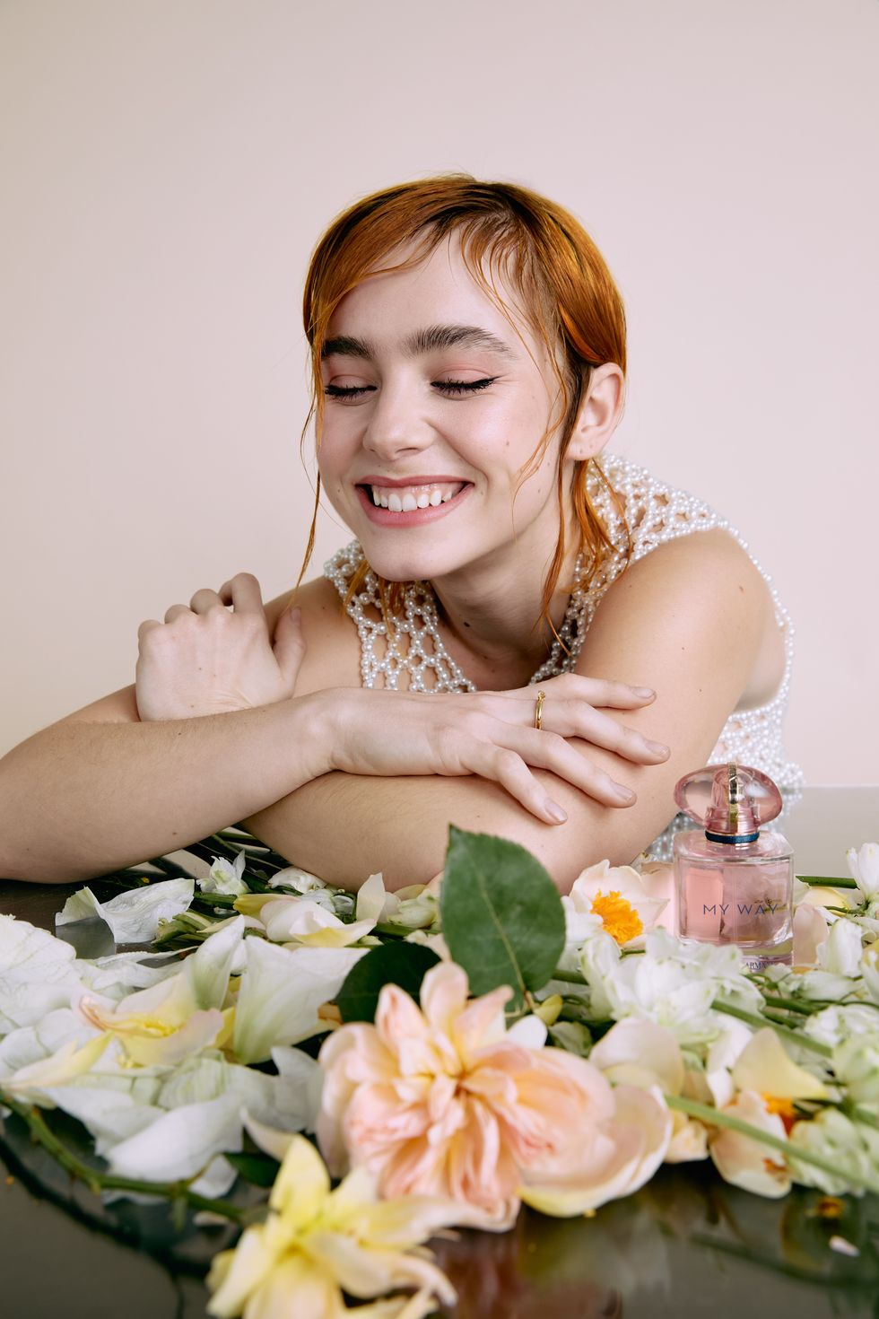 a person smiling with flowers in the hand