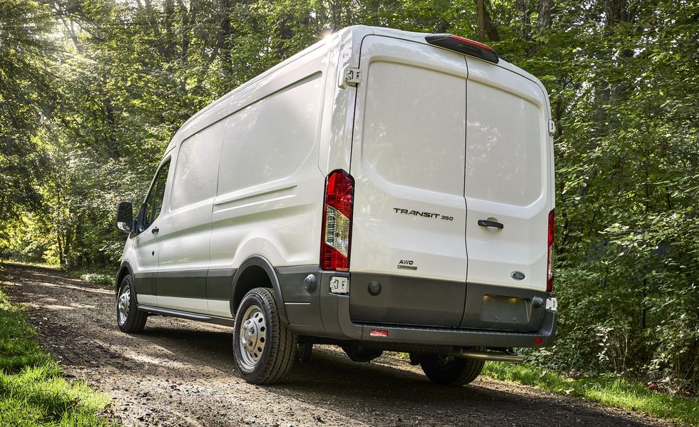2024 ford transit driving away on a forest road