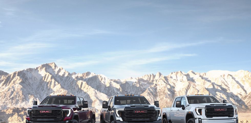 group shot of the 2024 gmc sierra 2500hd premium off road lineup from left to right sierra 2500hd at4x, sierra 2500hd at4x aev edition and sierra 2500hd at4