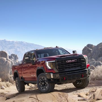 2024 gmc sierra 2500hd at4x in volcanic red tintcoat tackling rocky off road conditions