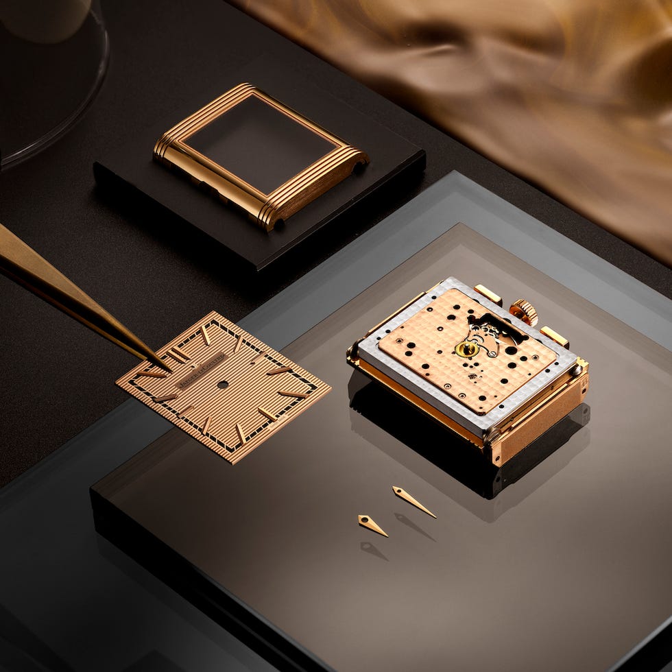 disassembled luxury watch components on a workspace