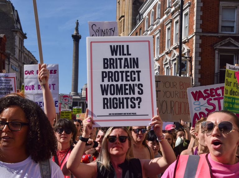 london, united kingdom, protester holds a placard which says will britain protect womens rights