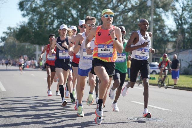 a group of people running on a road