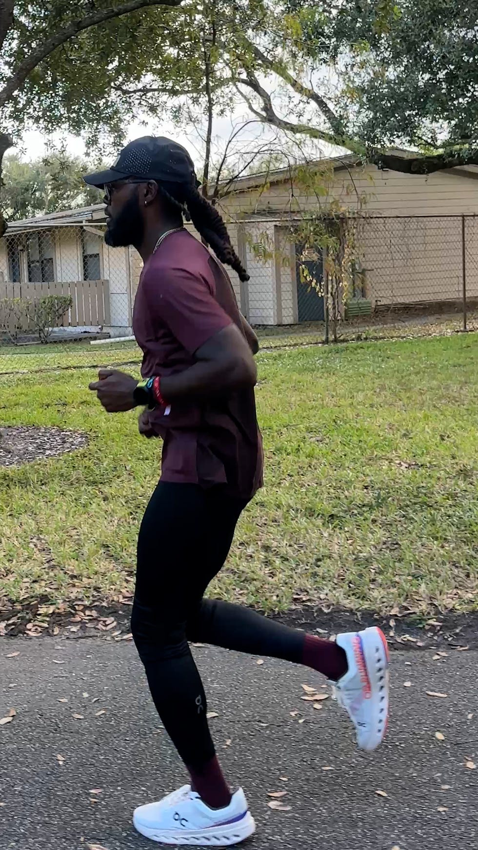 person jogging on a path with residential background