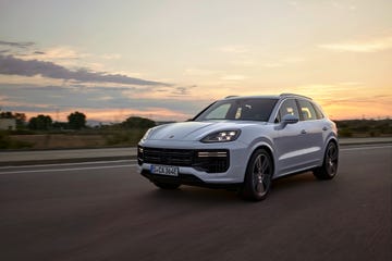 front three quarters view of 2024 porsche cayenne turbo e hybrid driving