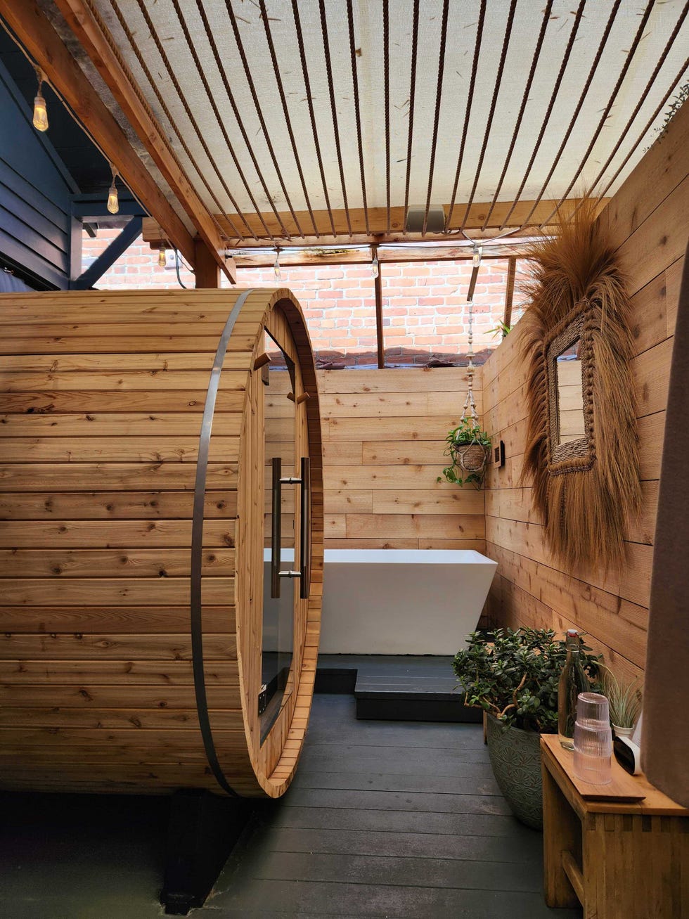 a room with a wood roof and a wood door with a white bed