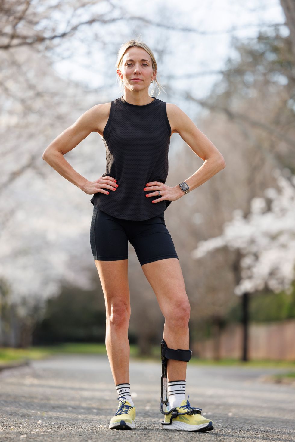 a woman poses for a portrait wearing running clothes