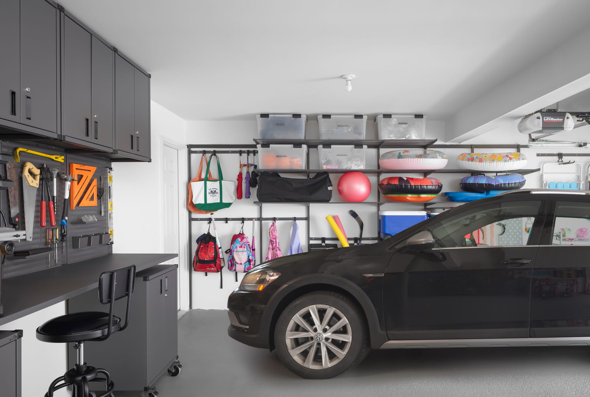 an organized garage with a car parked in it