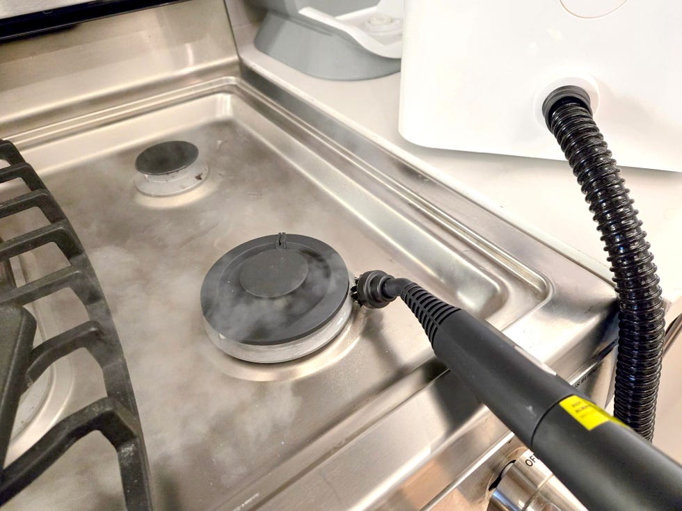 steam cleaning a stovetop with the dupray steamer