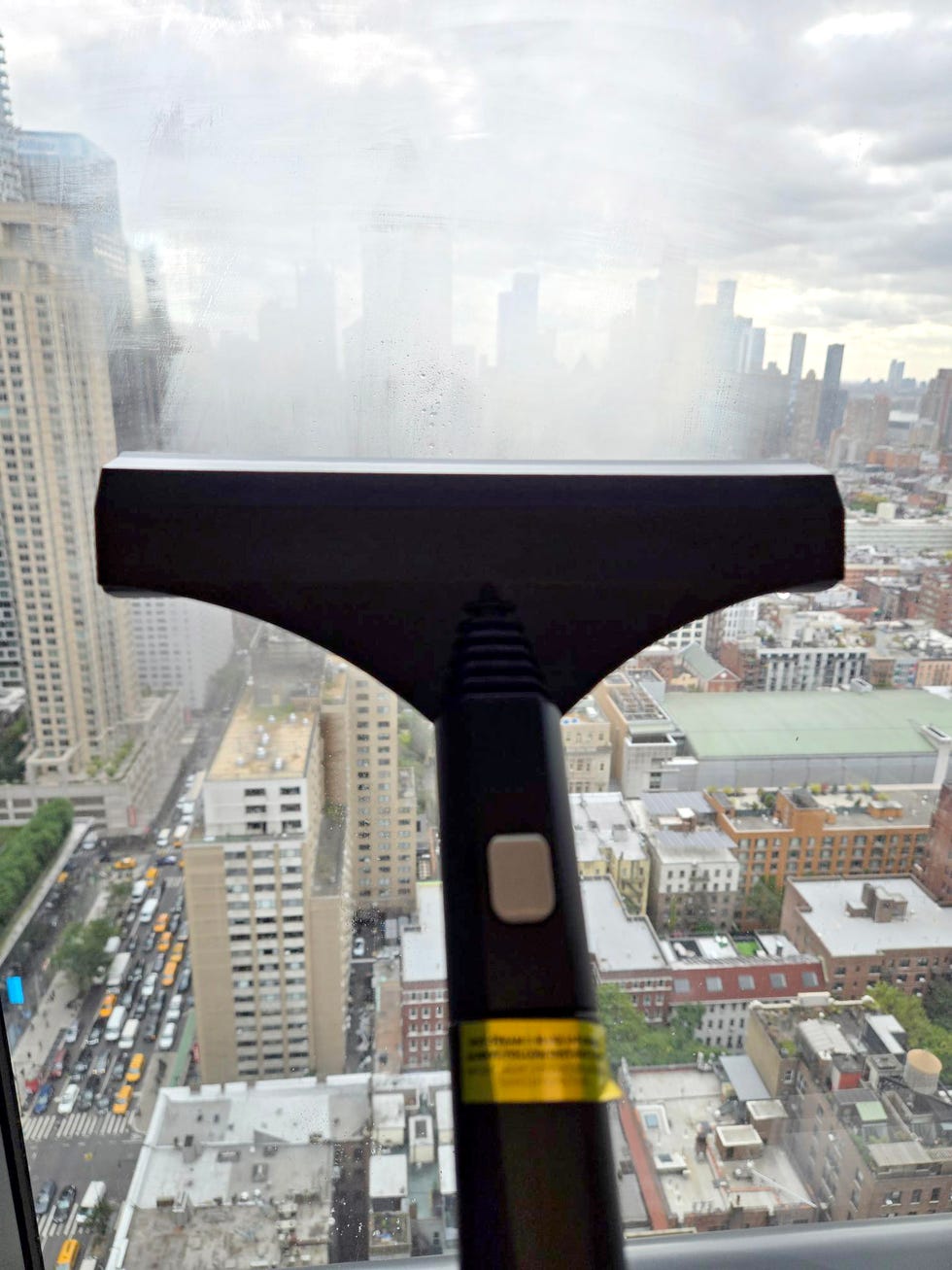 cleaning a window with the dupray steam cleaner squeegee attachment