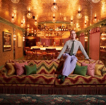 Martin Brudnizki in Flute bar at Broadwick Soho stylish lounge area with a vibrant couch and a bar in the background