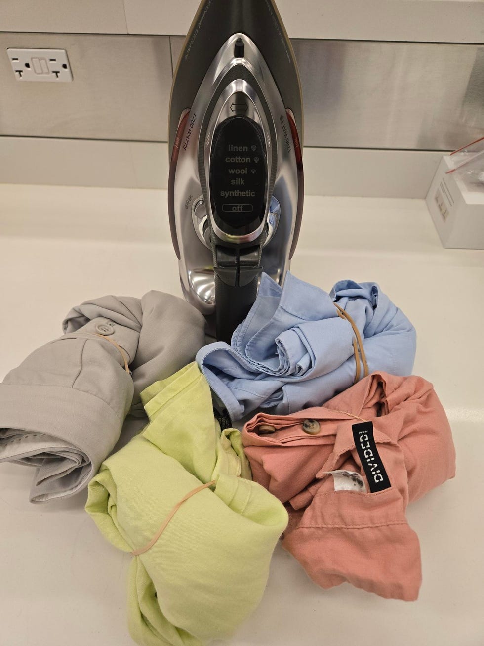 iron and folded shirts in various colors