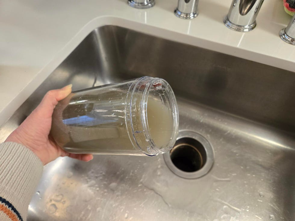 best vacuum mops emptying a tank of dirty water