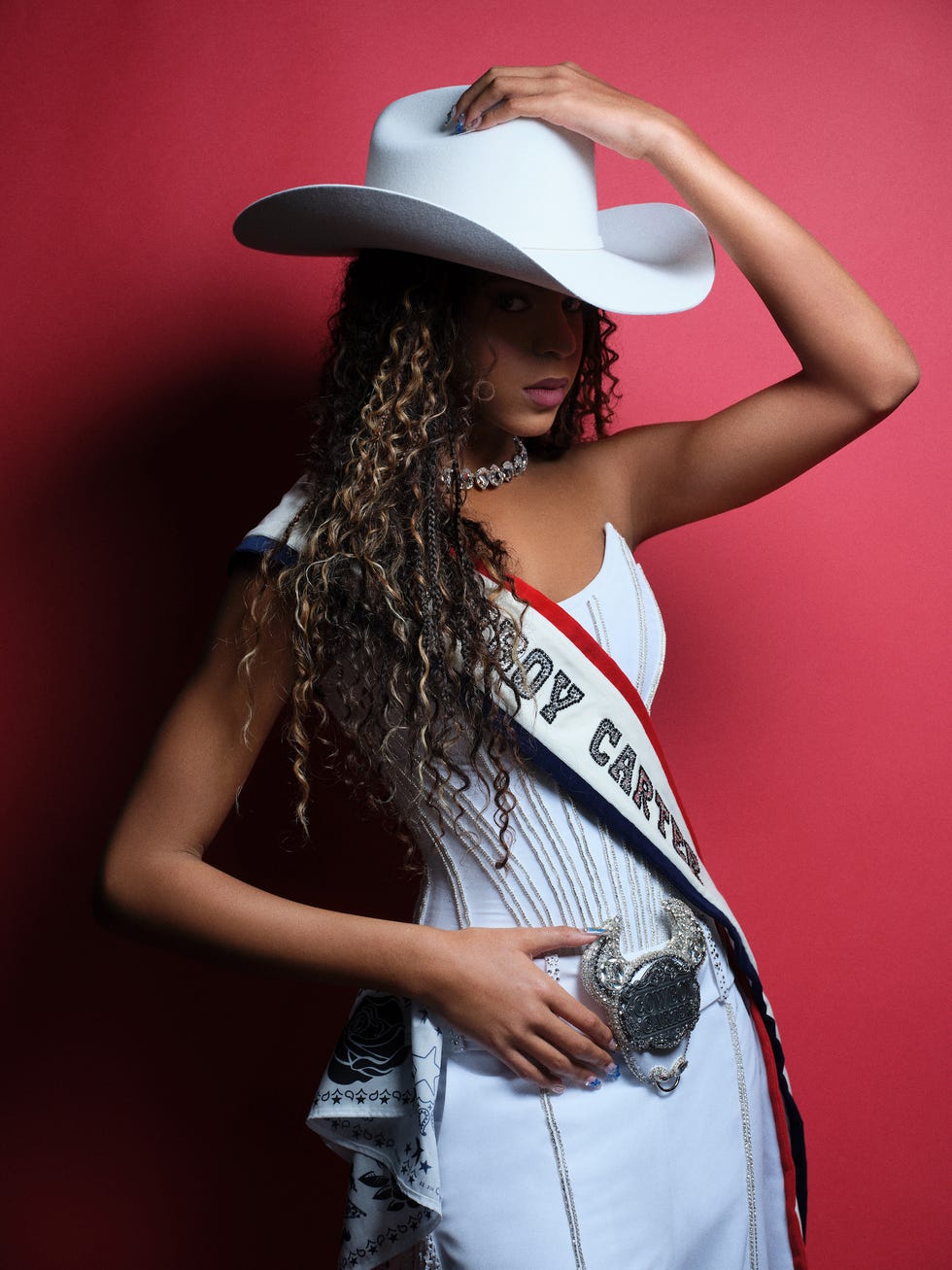 a person wearing a fancy outfit with a large hat and a sash