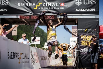 runner crossing the finish line at an outdoor race event sierre zinal 2025