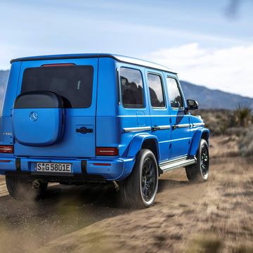 a blue 2025 mercedes g 580 with eq technology on a dirt road
