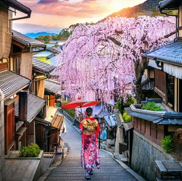 woman wearing japanese traditional kimono walking at historic higashiyama district in spring, kyoto in japan