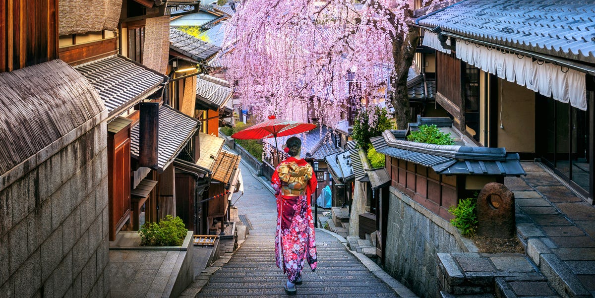 Woman wearing japanese traditional kimono walking at Historic Higashiyama district in spring, Kyoto in Japan. woman wearing japanese traditional kimono walking at historic higashiyama district in spring, kyoto in japan