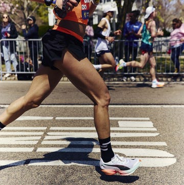 body of a runner taking part in a road marathon body of a runner taking part in a road marathon