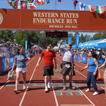 group of people on a track celebrating at a finish line group of people on a track celebrating at a finish line