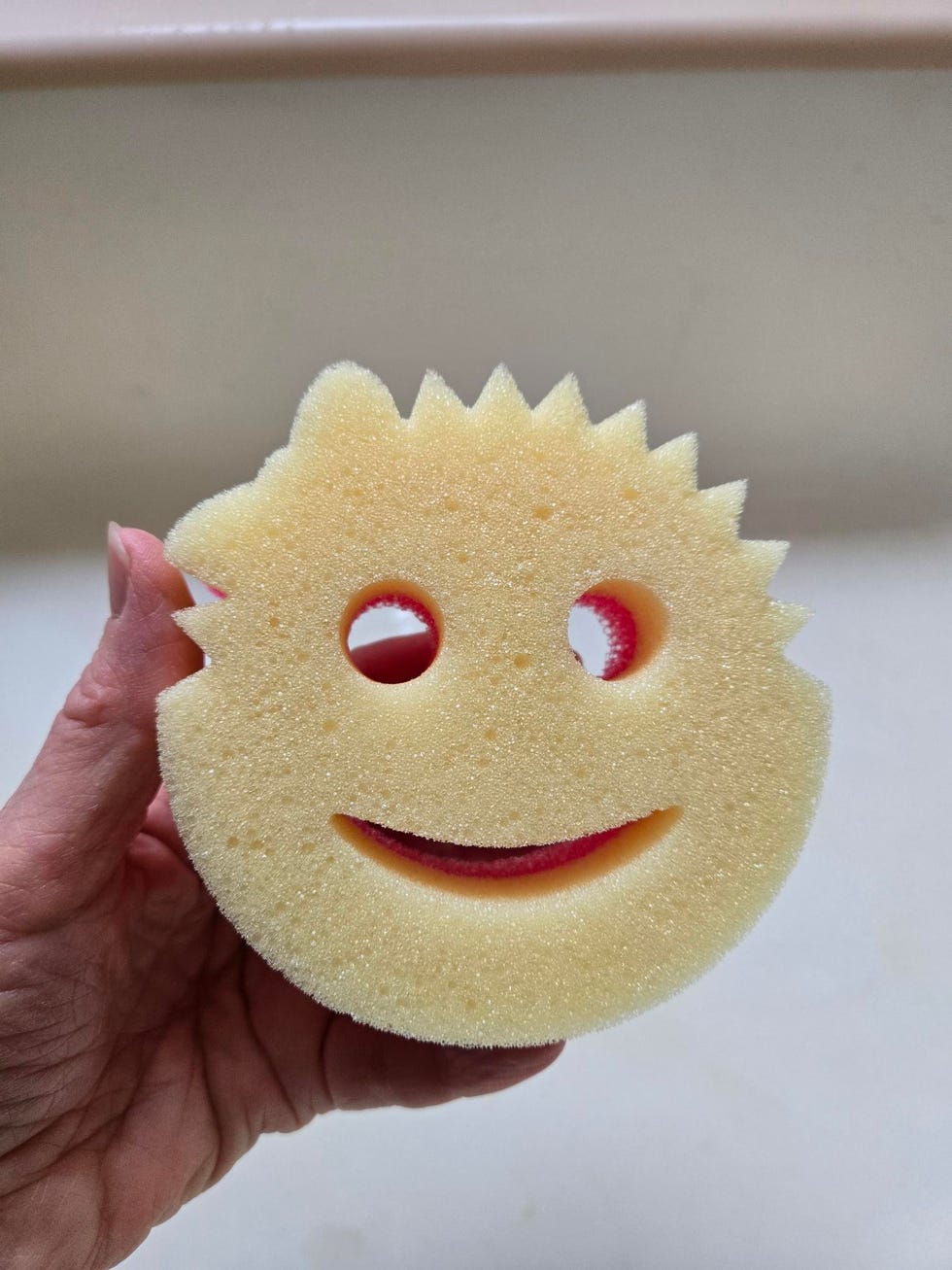 scrub mommy smiley face sponge with distinct features