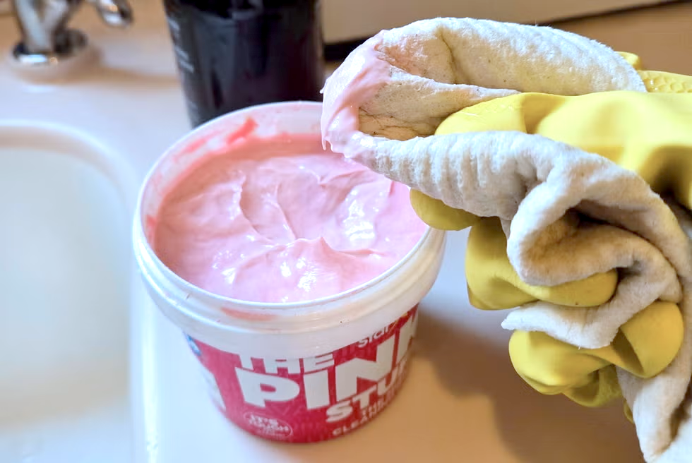the pink stuff review hand dipping a sponge into the pink stuff