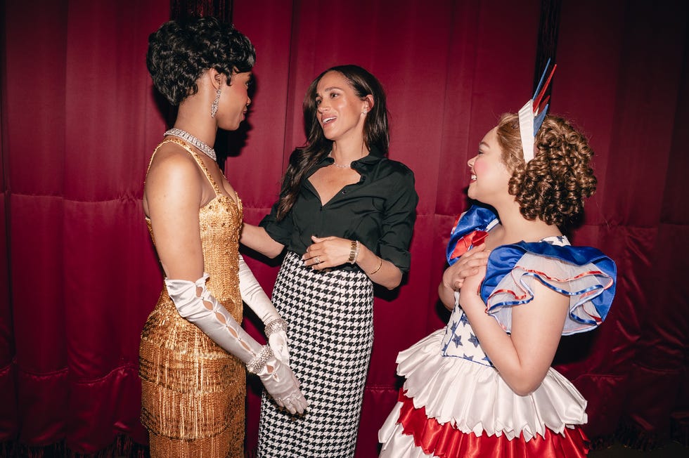 three individuals dressed in distinct costumes engaged in conversation