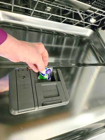 best dishwasher tablets inserting a dishwasher pack into the dispenser