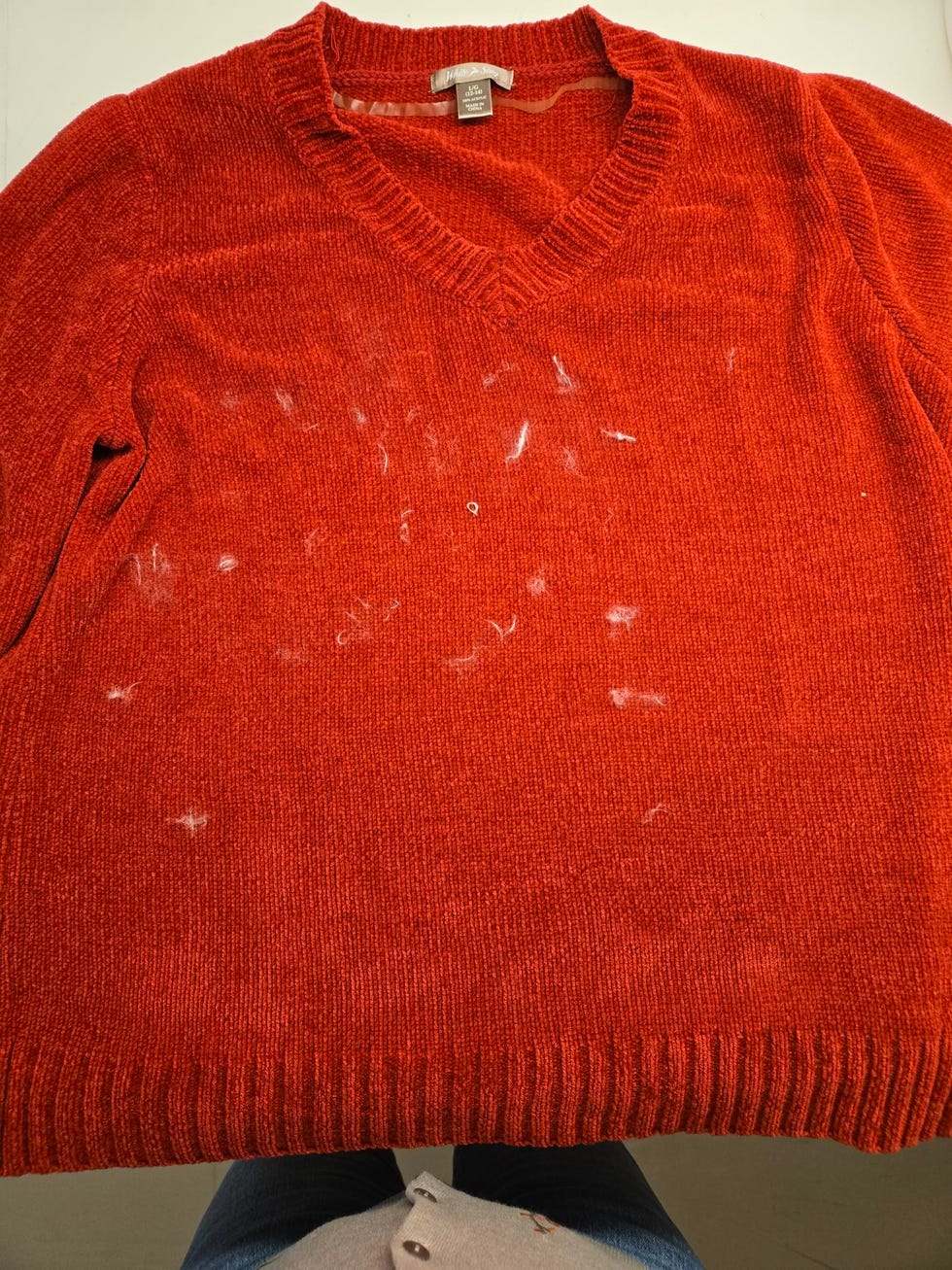 red sweater with simulated pet hair all over it