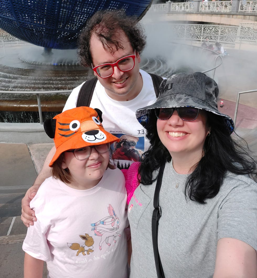 the author's family wearing hats in front of the universal globe
