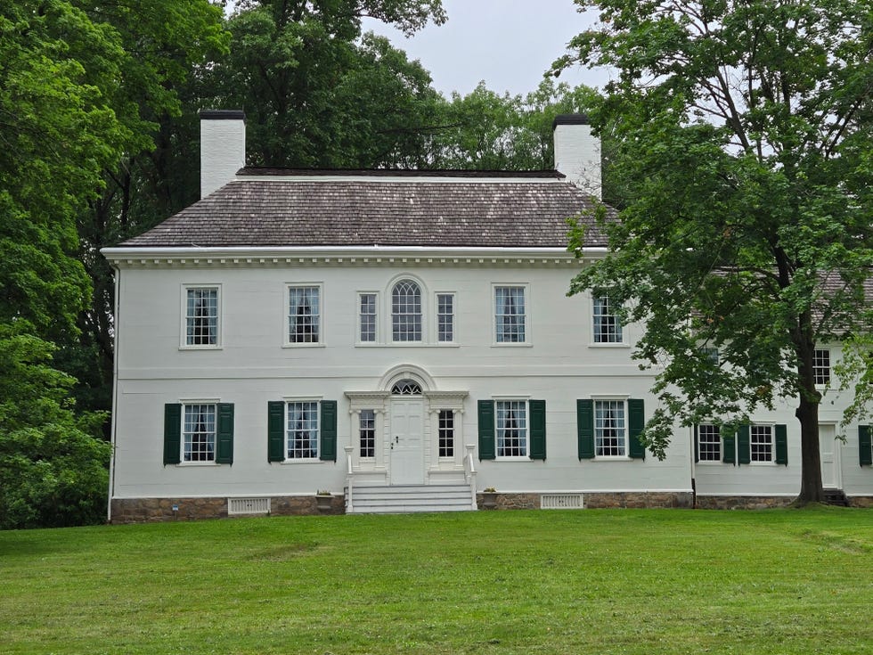 a large white colonial mansion